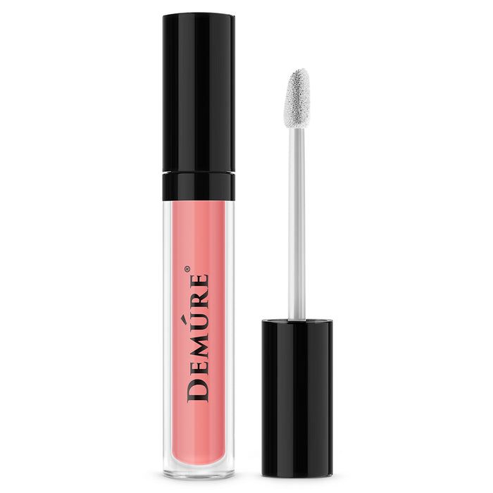 A tube of Demure Matte Liquid Lipstick Lovely 100 with a black cap, alongside an application brush.