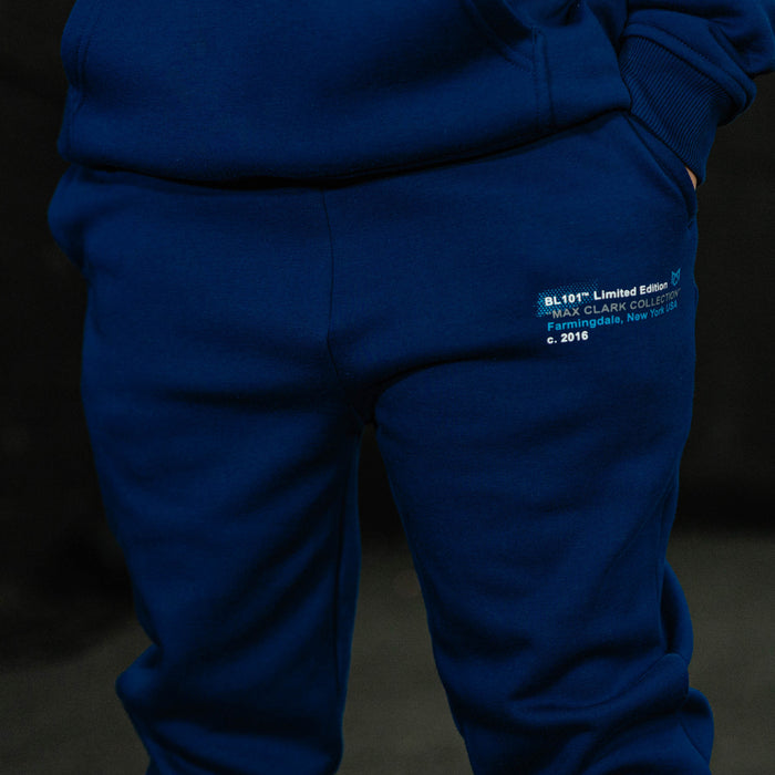 Blue tracksuit with a visible brand label on a dark background