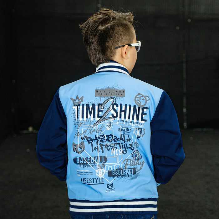 Youth model wearing blue Max Clark Bomber youth bomber