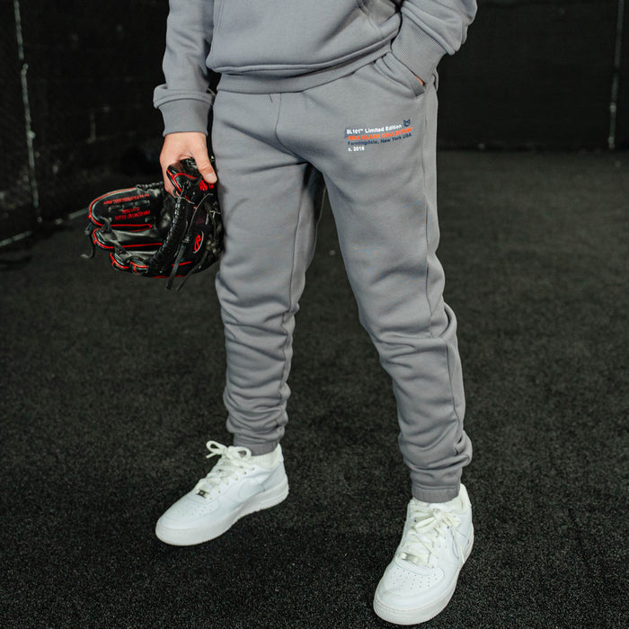 Youth model wearing gray Max Clark youth sweatpants