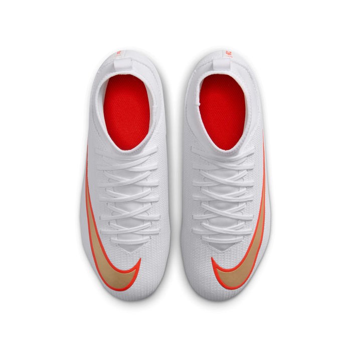 Youth soccer cleats, tongue and laces with red-orange lining, white upper