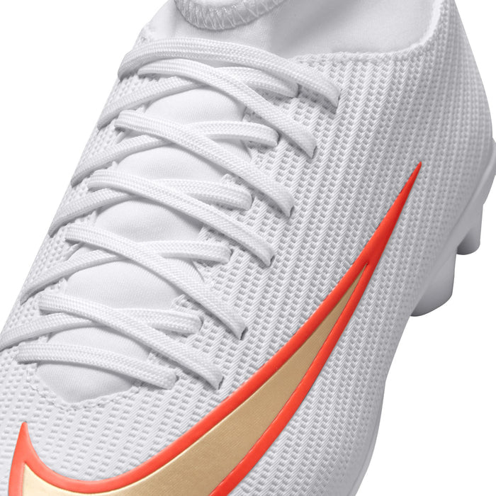 Youth soccer cleats, close-up laces, white textured upper with orange Nike swoosh