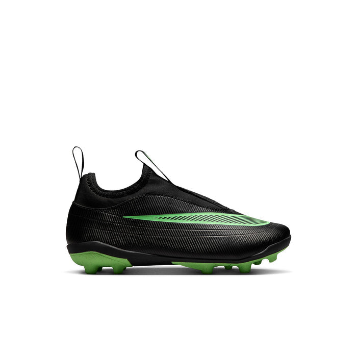 Kids black soccer cleat with green trim, low-cut upper, and molded field studs