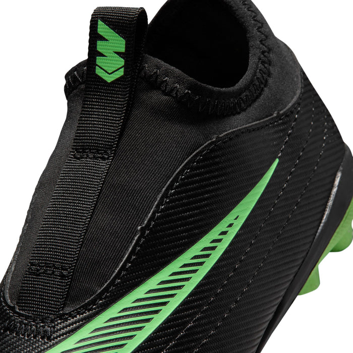 Kids black cleat upper close-up with green stripe graphic and textured finish