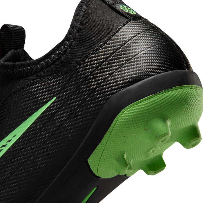 Kids black cleat side close-up with green outsole pods and textured upper