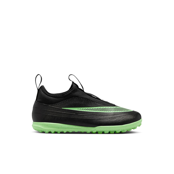 Kids black soccer cleats with green accents, low-cut slip-on design, turf outsole