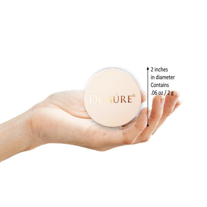 Hand holding a Demure Blush Jar with text indicating its size and weight