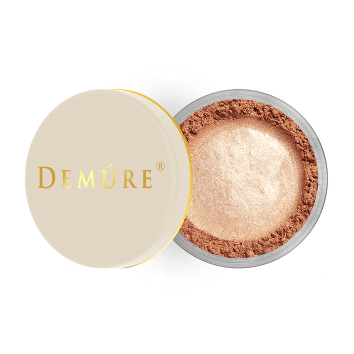 Open 2g container of Demure Face & Body Bronzer with a gold lid