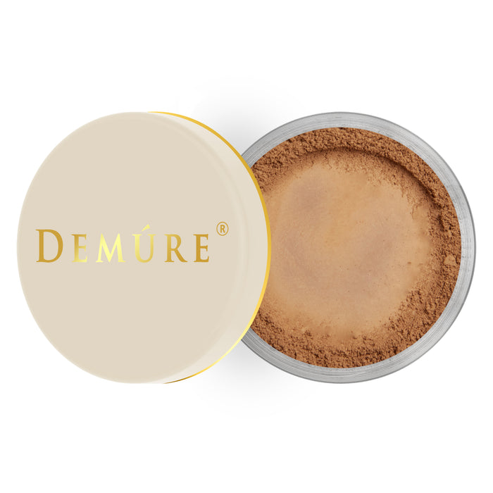 Open container of Demure Dark color loose foundation with a gold lid