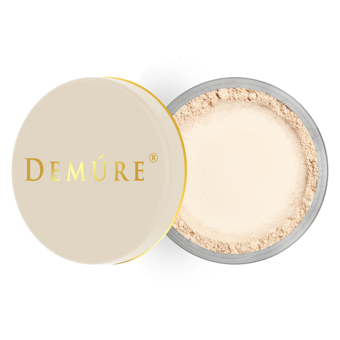 Open container of Demure Light color loose foundation with a gold lid