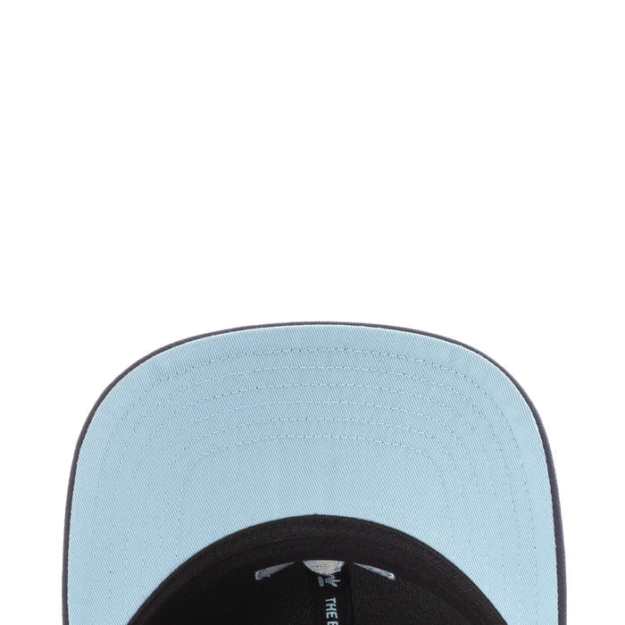 Light blue underside of snapback cap brim with stitched Adidas label
