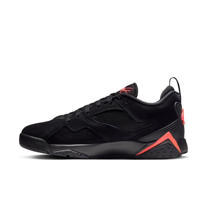 Black low-top sneaker with textured side panels and red-orange accent on midsole