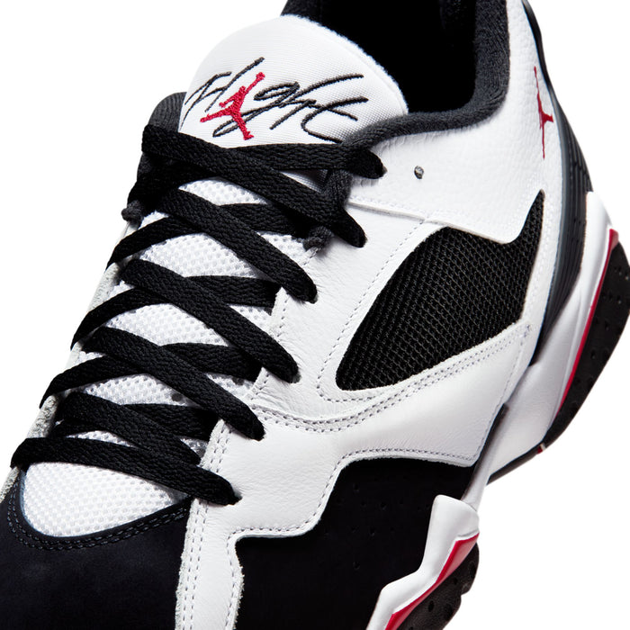 Men's basketball sneakers close-up, white leather with black overlays and red trim