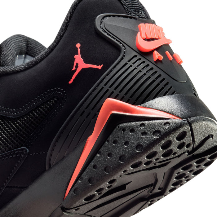 Close-up heel and sole of black sneaker with red-orange Nike logo and traction pods