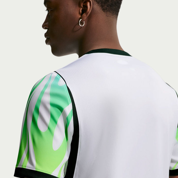 White jersey back with green flame graphic on sleeve and black edge collar trim.