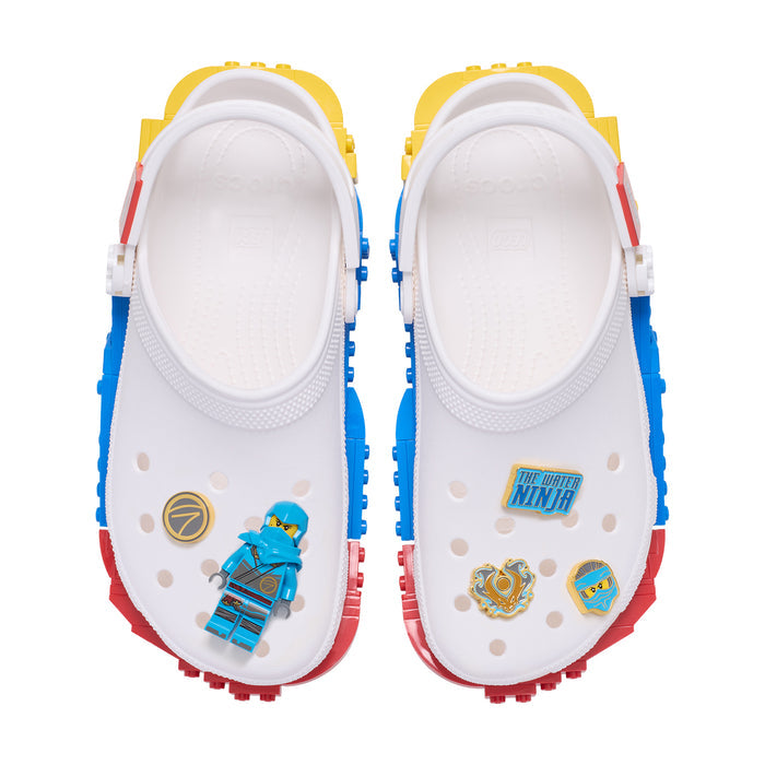 Crocs clogs showing LEGO Ninjago Nya Jibbitz charms: character, emblem, and logo pieces.