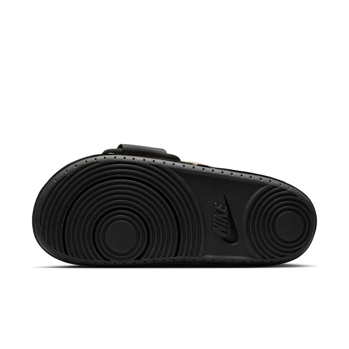 Men's slide sandal outsole in black with circular traction pattern and Nike logo