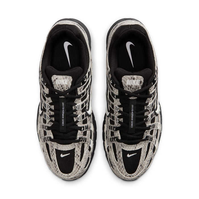 Women’s athletic sneaker, top view showing black laces and Nike logo on tongue
