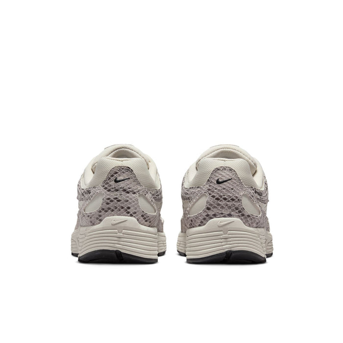 Women's Nike sneakers from heel view, light bone upper with gray snakeskin pattern
