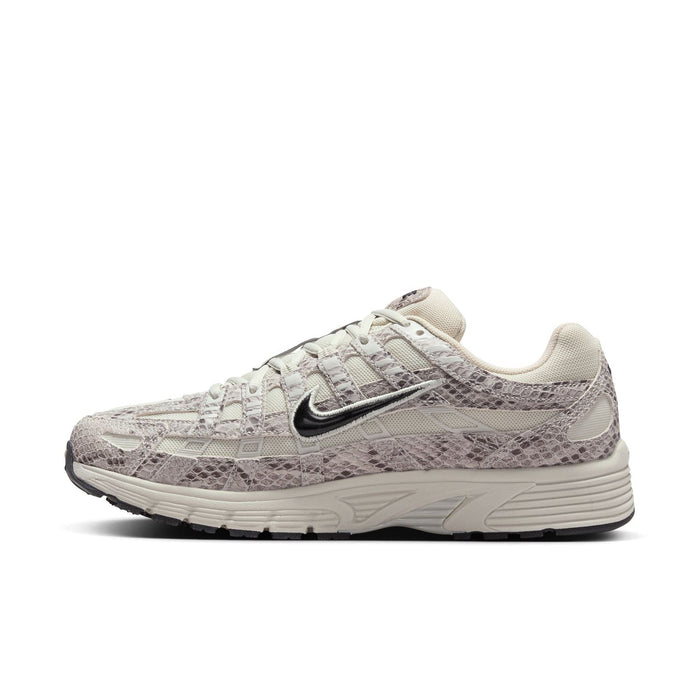 Women's Nike sneaker side profile, light bone base with gray snakeskin textured panels