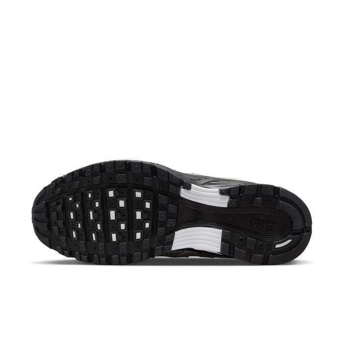 Women’s athletic sneaker outsole with black tread and light midsole panel