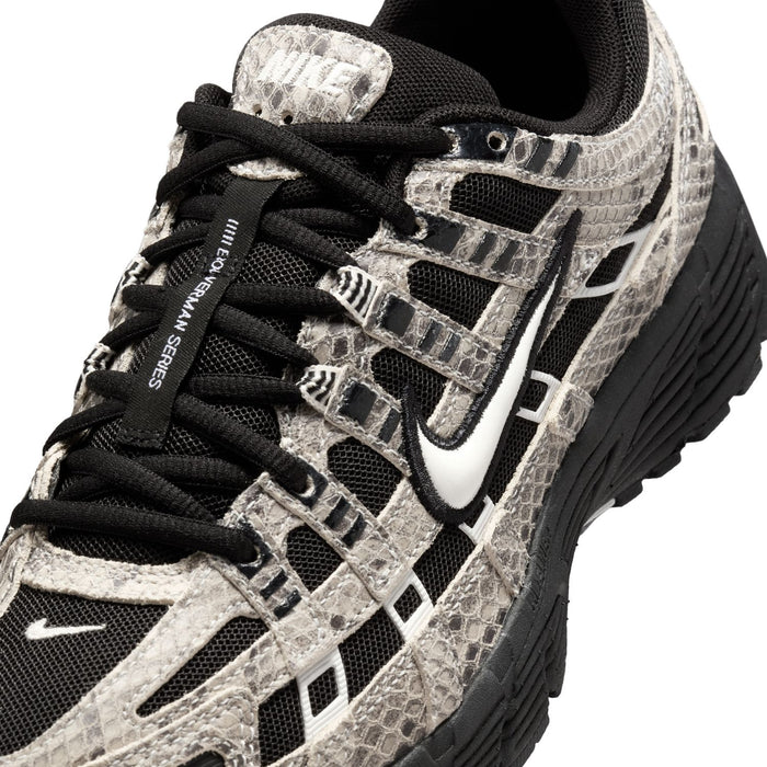 Women’s athletic sneaker close-up of laces and snakeskin pattern with swoosh detail