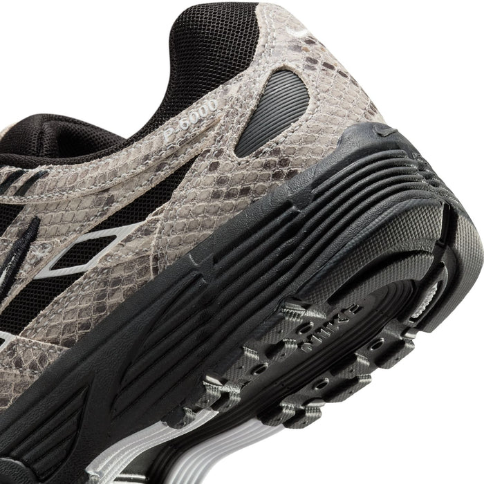 Women’s athletic sneaker close-up of side panel and ribbed sole cushioning