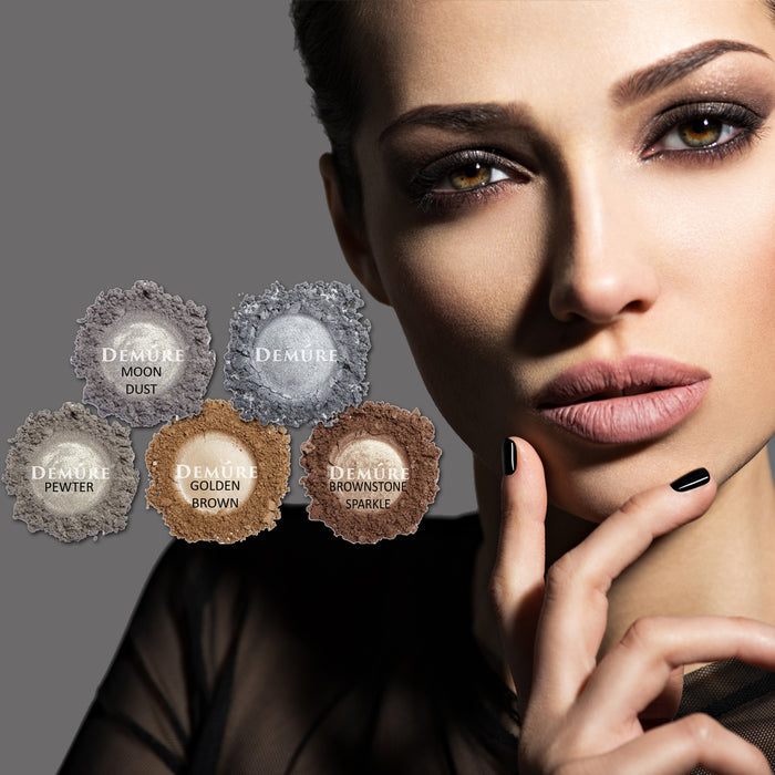 Woman wearing smoky eye makeup with six Demure silver shimmer eye colors in the foreground