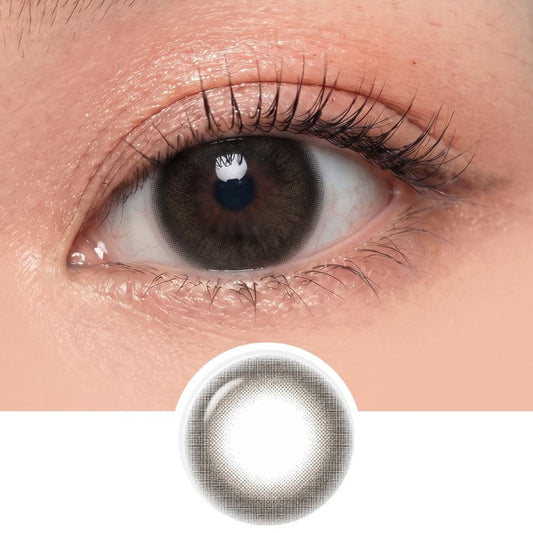 A close-up of an eye wearing EyeCandys Pink Label Marshmallow Grey contacts, with a separate image below showing the lens’s design—a soft grey tint and patterned edge—for those seeking natural-looking grey contacts.