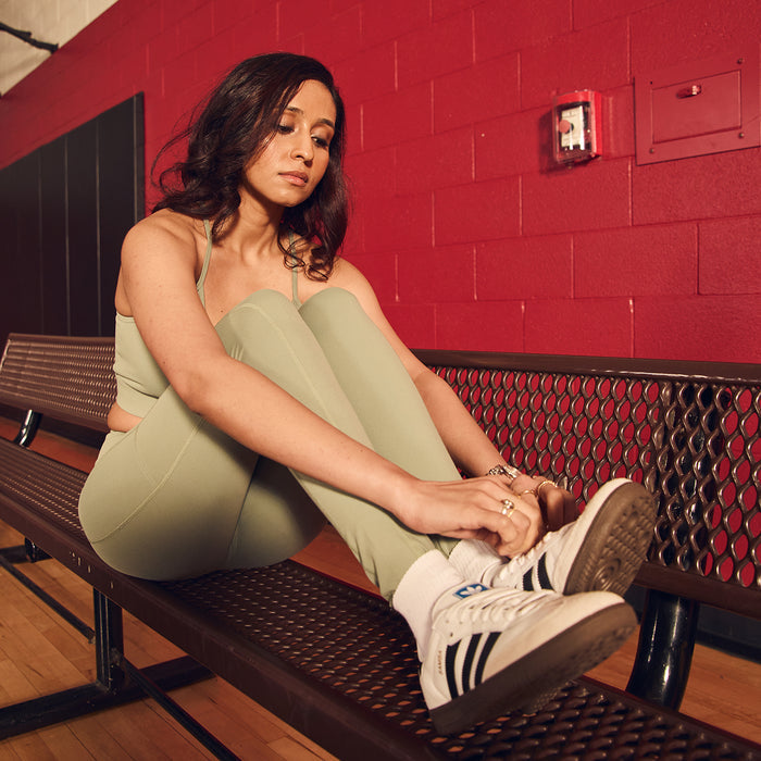 Womens high-waist sea spray green leggings worn with sneakers, full-length.