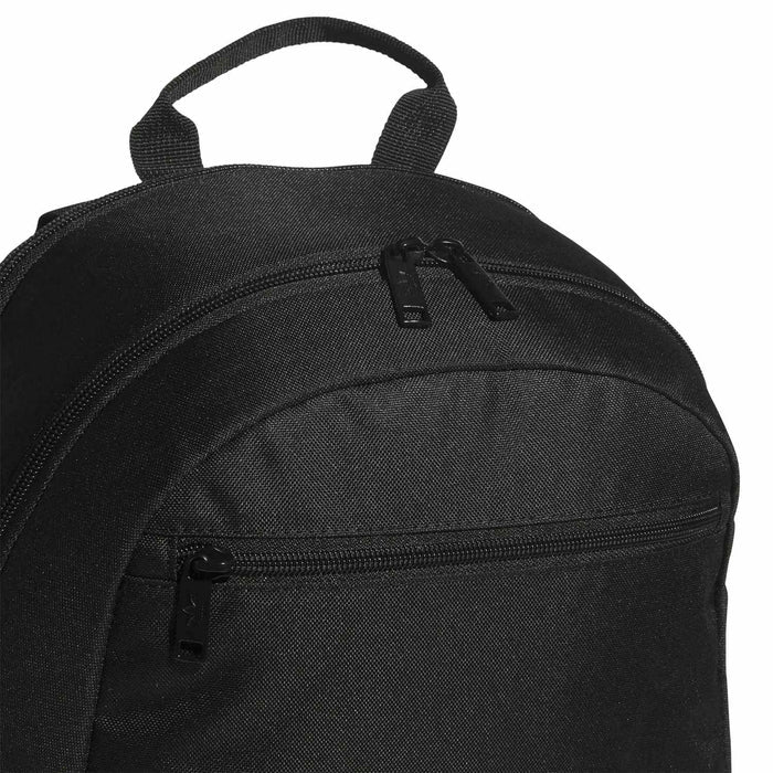 Black backpack close-up: large front zipper, top handle, and webbing strap