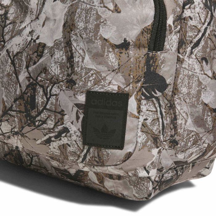 Camouflage backpack fabric close-up with logo patch on front panel