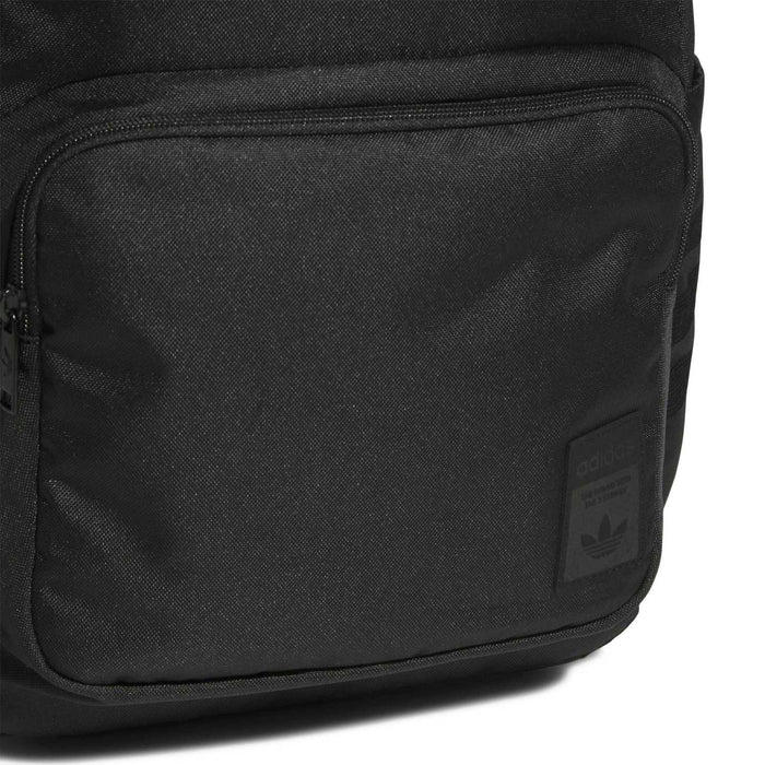 Black backpack front panel with zip pocket and small logo patch