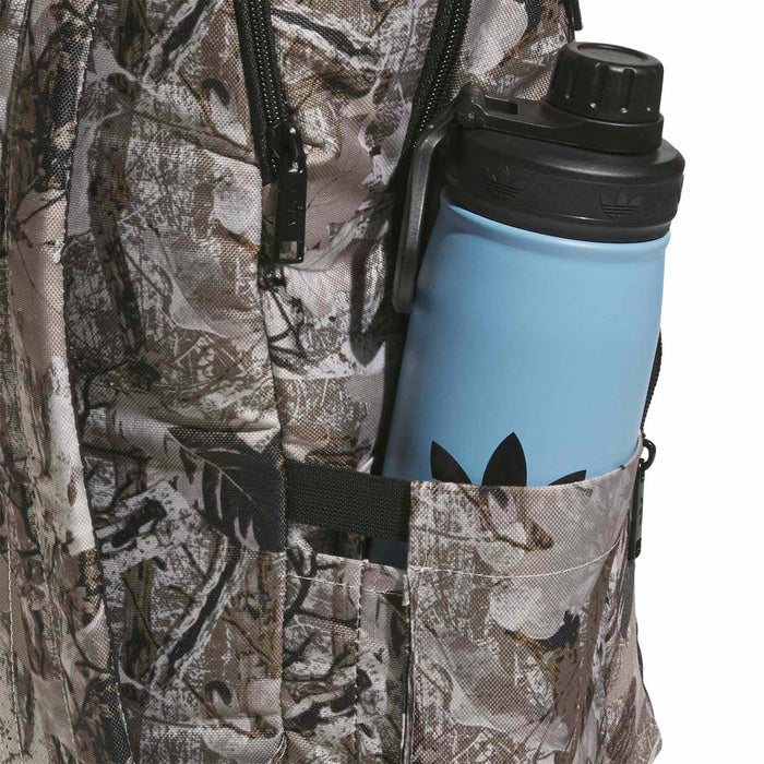 Camouflage backpack with side bottle pocket holding a blue bottle