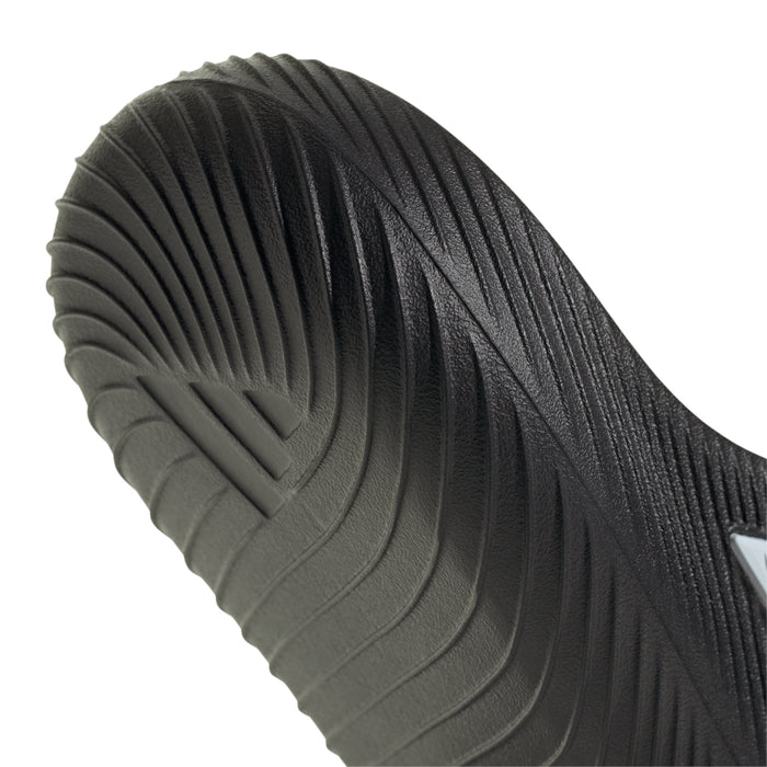 Black slide sandal heel with molded tread pattern and contoured cushioning