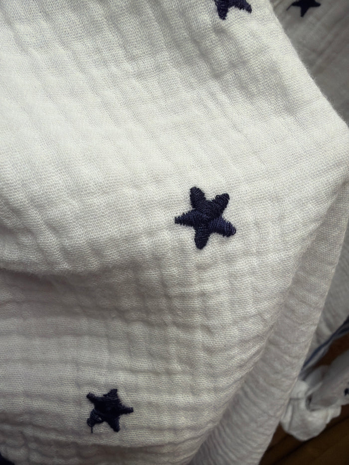 Camille & Co. Reach for the Stars blouse featuring a celestial star print, long sleeves, and a relaxed fit.