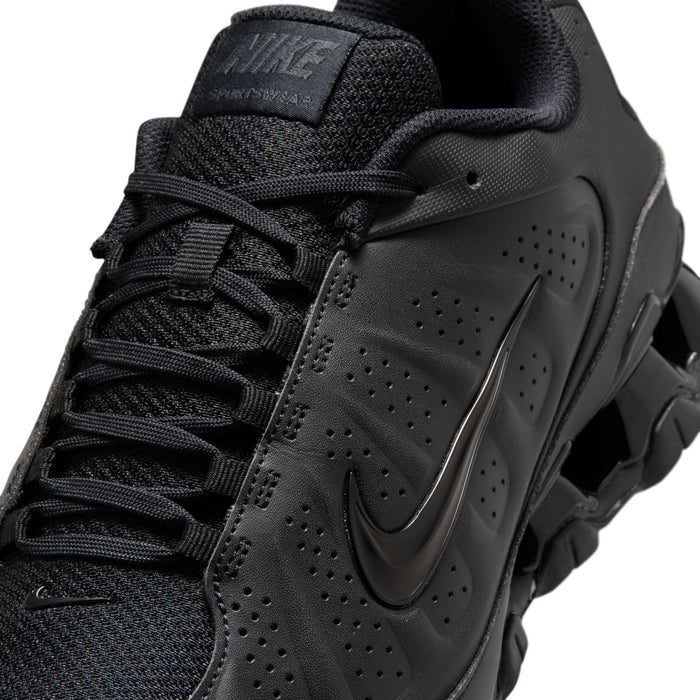 Men's black Nike sneaker upper close-up with perforations and side swoosh