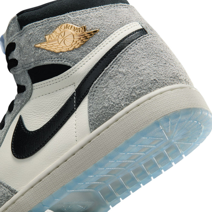 Close-up of mens high-top sneakers with gold wing emblem on gray suede and black Swoosh