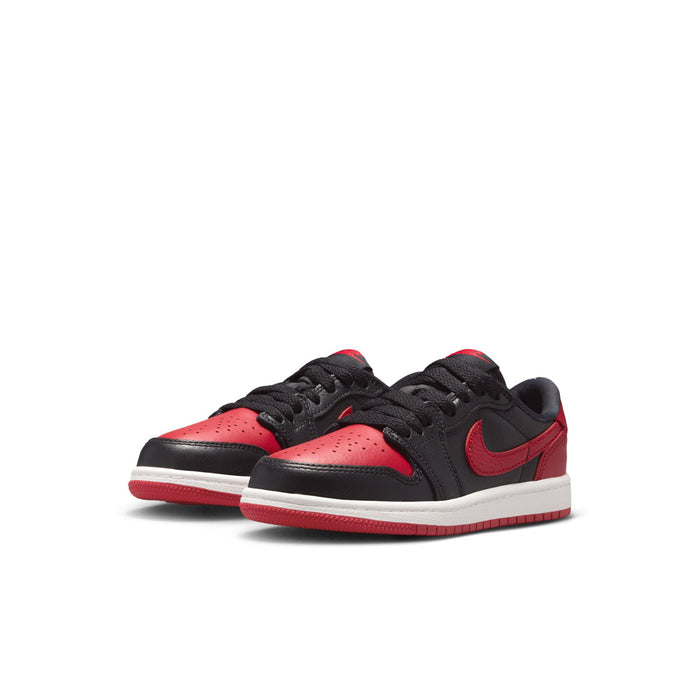 Pair of kids black and red low-top sneakers with red swoosh and white midsole.