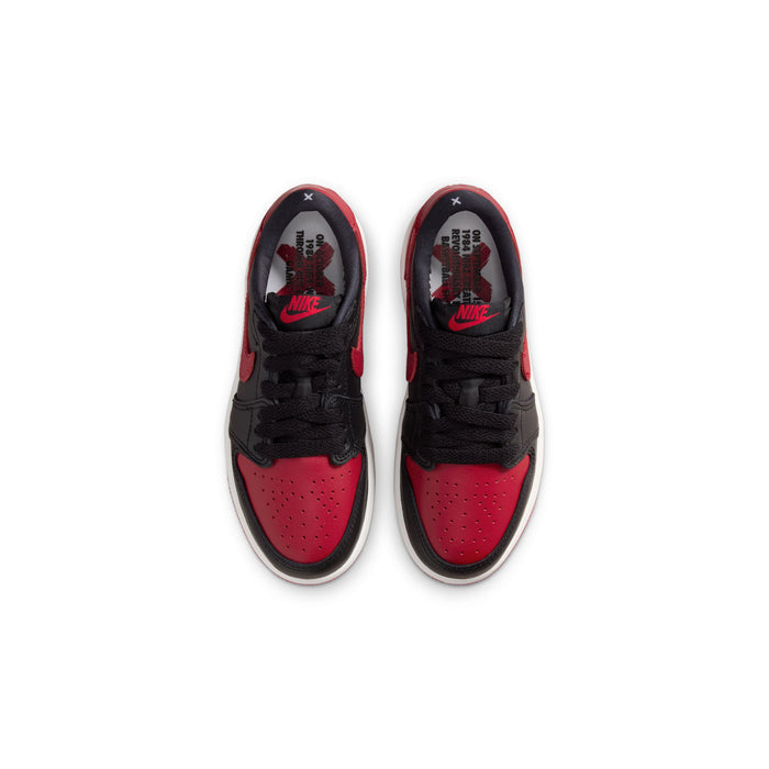 Kids black and red low-top sneakers with laces, showing tongue logos and perforated toe.