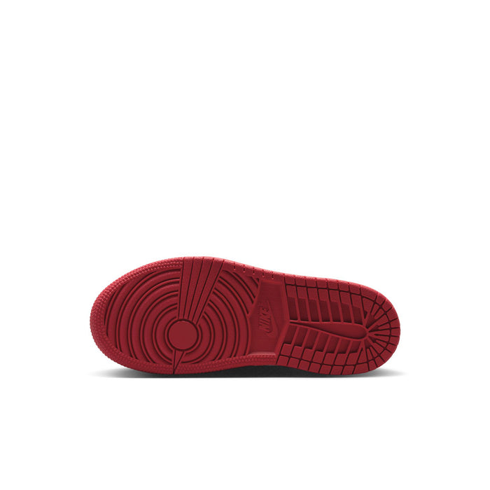 Red rubber outsole for kids low-top sneakers with textured traction pattern.