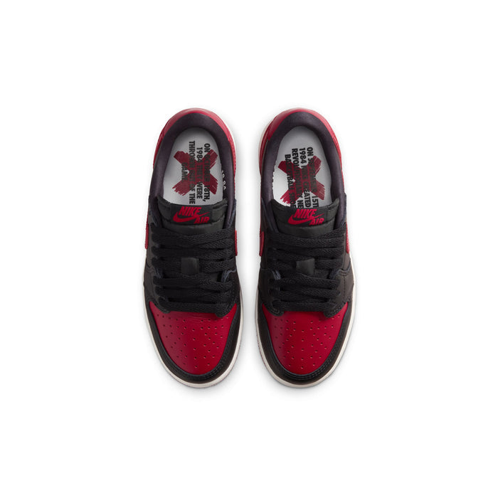 Youth sneaker top view, black laces and red-tinted inner tongue label
