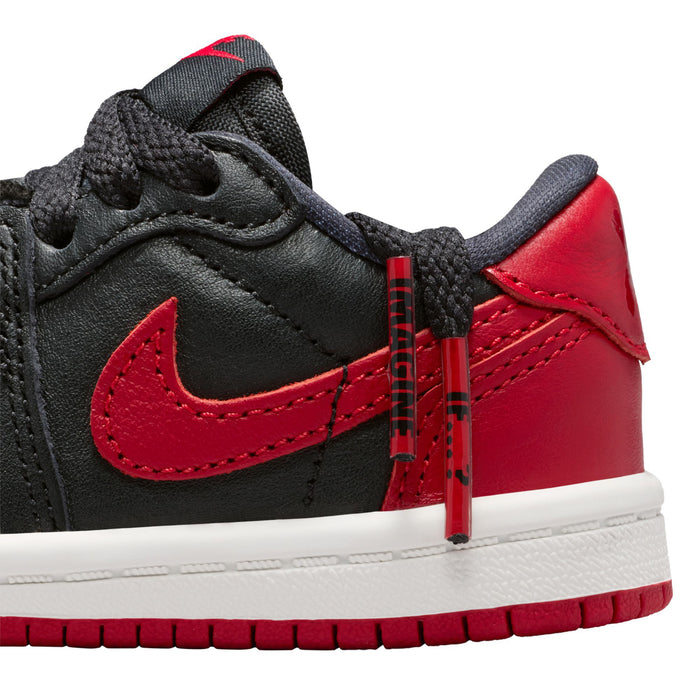 Toddler sneaker close-up, black and red panels with stitched Nike swoosh