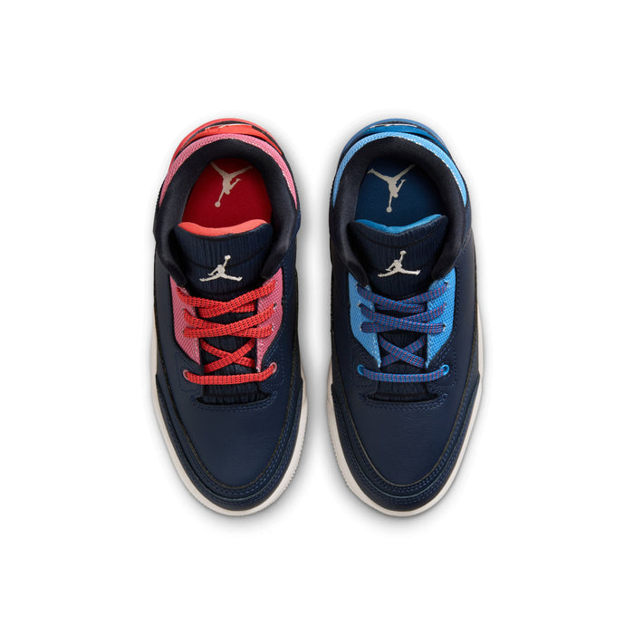 Kids sneakers showing two uppers: navy with red laces and navy with blue laces