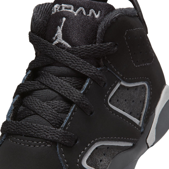 Black toddler sneaker upper close-up with laces, stitched panels, and heel logo