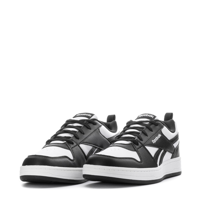 Pair of youth Reebok sneakers, black-and-white low-top with lace-up and side stripes