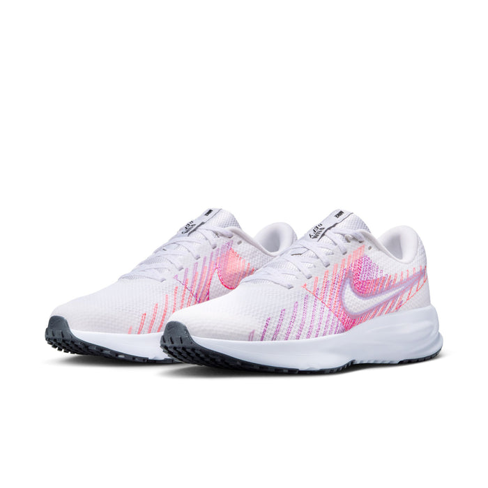 Women’s running shoe side view: white knit upper with pink/purple Nike swoosh, thick sole.