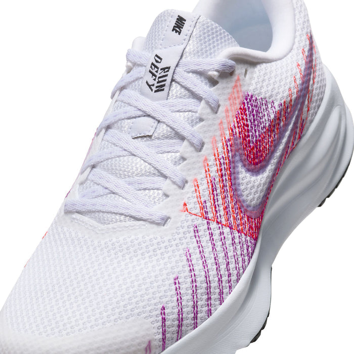 Women’s running shoe close-up: white knit with pink/purple swoosh, white laces, heel padding.