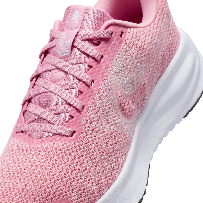 Women’s running shoes close-up: pink knit upper with lace-up and padded collar
