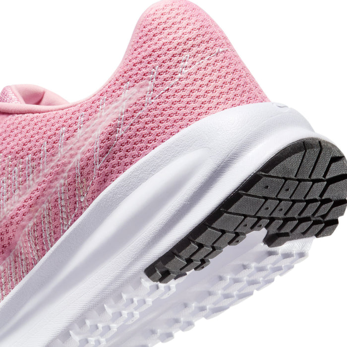 Women’s running shoes close-up of heel: pink knit upper with white cushioning sole